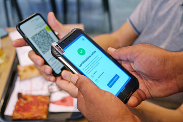 Positive green pass check on smartphone, required for indoor tables in restaurants and bars Selective focus  Turin, Italy - August 2021