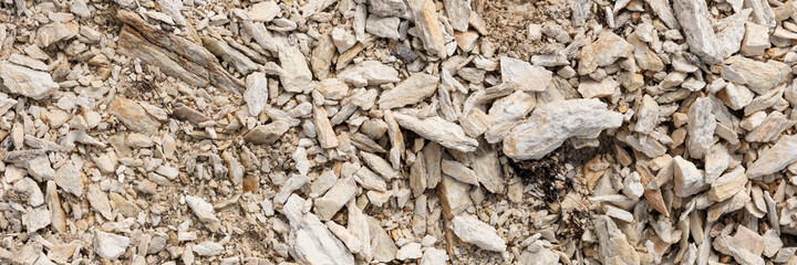 Pointed bright granite stones as a background. Panoramic image