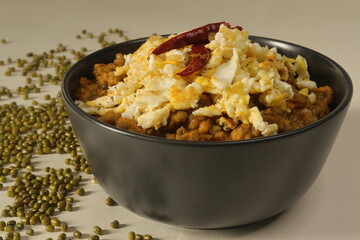 Green moong beans gravy with onion tomato and spices served with scrambled egg on top. Locally known anda tadka.