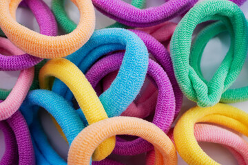 Closeup of various hair ties. Macro of multicolored elastics. - obrazy, fototapety, plakaty