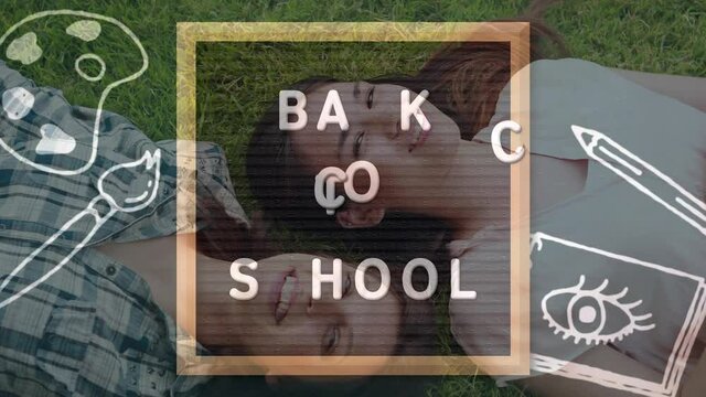 Back to school text on wooden slate against two caucasian female college students lying on the grass