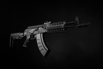 A pneumatic copy of a Russian machine gun. Modern airsoft weapons. Dark background with red...