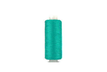 Green thread on a spool isolated on a white background.