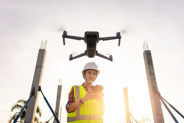 Asian woman engineer surveyor control drone for aerial view structure inspection in project...
