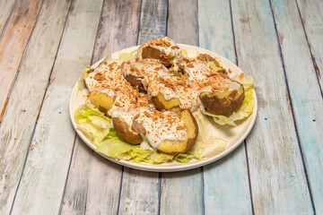 Potatoes cooked in their own skin, cut in half and drizzled with Cabrales cream cheese