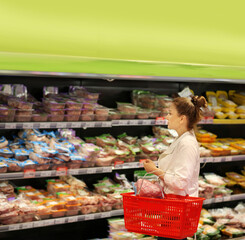 Woman choosing a dairy products at supermarket