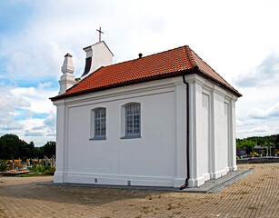 Fototapeta na wymiar Built in 1924, a Catholic cemetery chapel dedicated to the Holy Spirit in the town of Choroszcz in Podlasie, Poland.