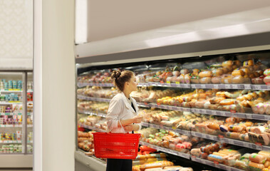 Woman choosing a dairy products at supermarket