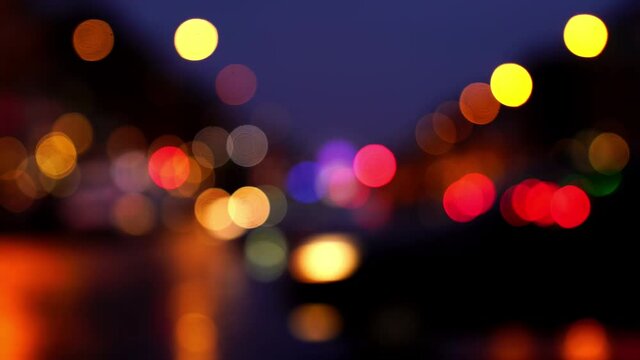 Blurred background, the city street lights and the taillights of cars turning into colorful light spots