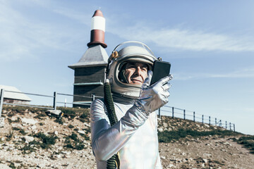 Senior cosmonaut using mobile phone