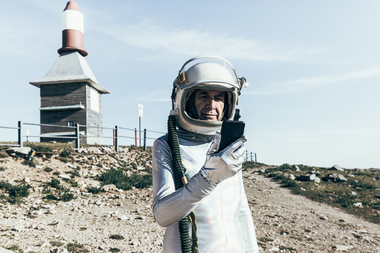 Senior cosmonaut using mobile phone