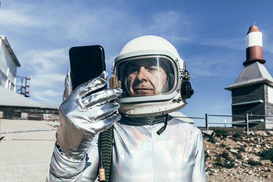 Senior cosmonaut using mobile phone