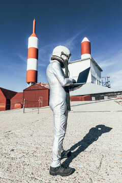 Cosmonaut using laptop near base