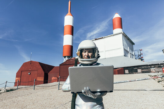 Cosmonaut using laptop near base