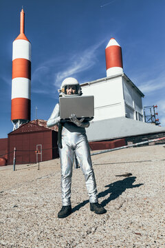 Cosmonaut using laptop near base