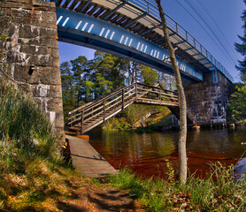 Stone railroad bridge over stream in Ryfors Gammelskog Natural Reserve, Mullsjo, Jonkoping, Sweden