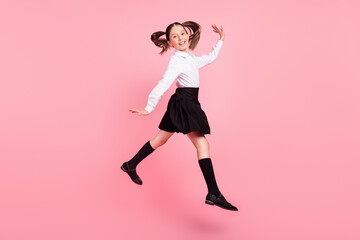Fototapeta na wymiar Full body photo of cheerful young happy girl jump up good mood wear uniform isolated on pink color background