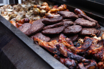 Large selection of grilled meats on a barbecue