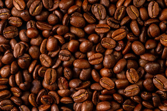 Natural background for Cafe menu or brochure template - macro photo of brown roasted coffee beans, close up © Wingedbull