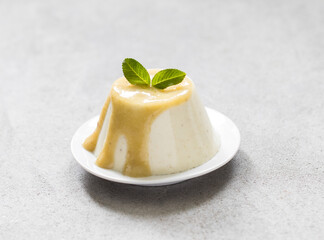 Panna Cotta gooseberry with sauce on a light background