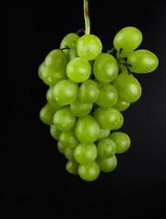 A bunch of grapes, white filling, with large sponges, on a black background