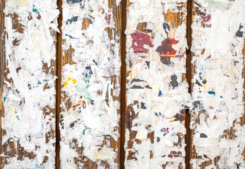 Colorful torn posters on grunge old walls.as background or texture
