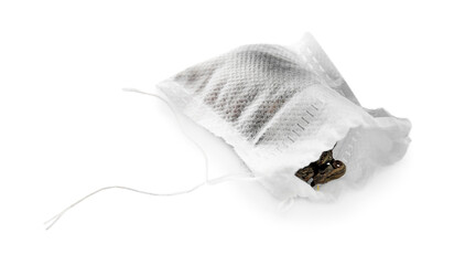 Tea bag with dry leaves on white background