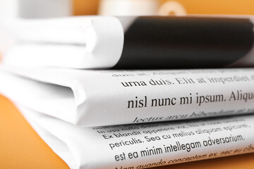 Newspapers on color background, closeup