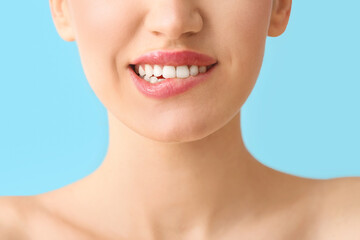 Obraz premium Young woman with beautiful lips on color background, closeup