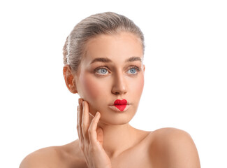 Obraz premium Beautiful young woman with heart painted on lips against white background