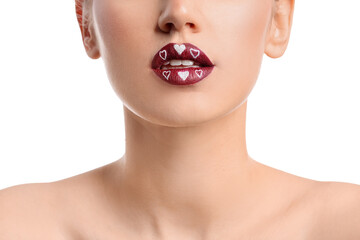 Beautiful young woman with hearts on lips against white background, closeup