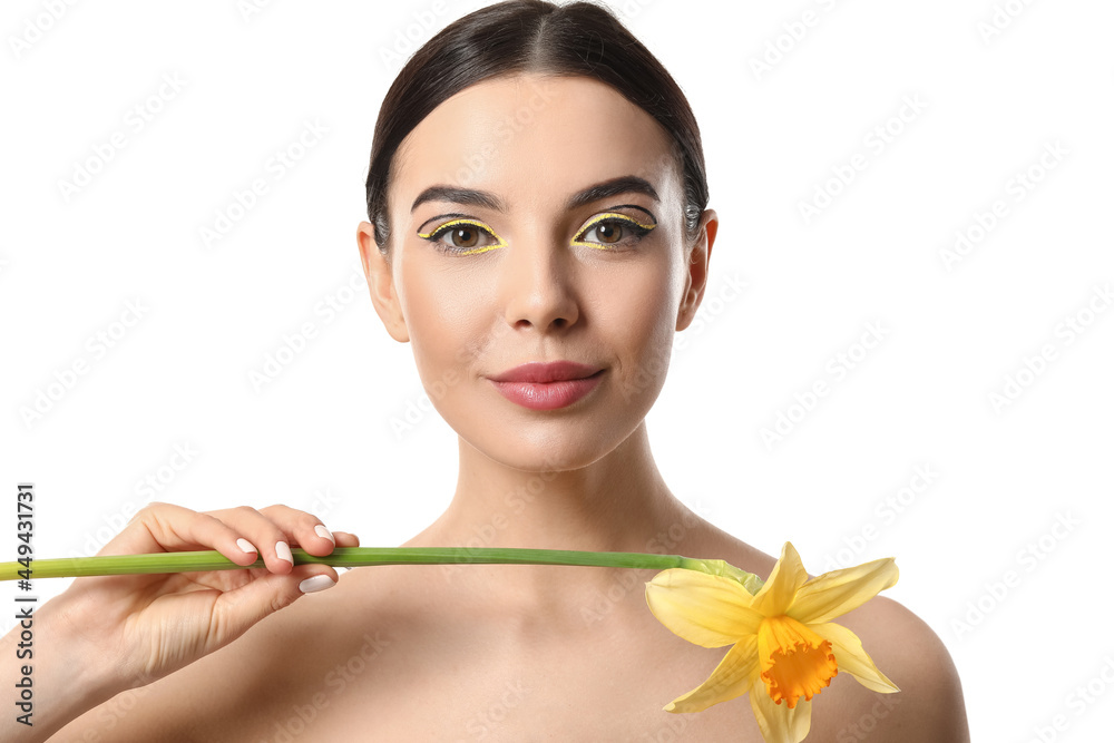 Wall mural beautiful young woman with stylish makeup and flower on white background