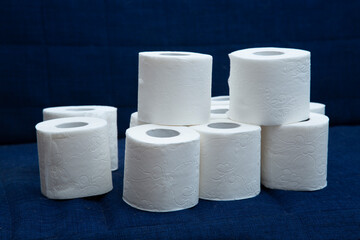 Toilet paper on a dark blue background. Personal hygiene items.