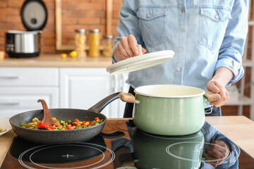 Woman cooking dinner in kitchen