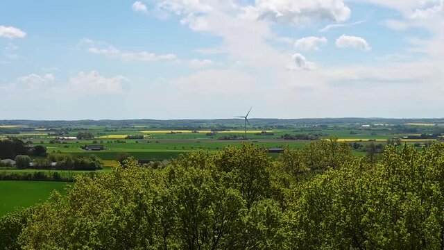 Flat farmland in Skåne Sweden with renewable wind turbine energy