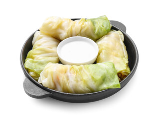 Frying pan with uncooked cabbage rolls and sour cream on white background