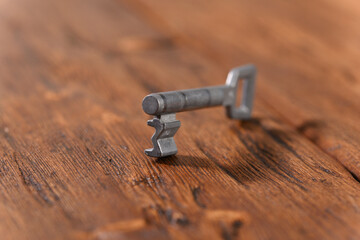 Key on wooden table  close up.