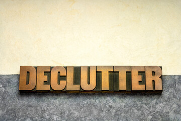 declutter word in vintage letterpress wood type against handmade textured amate paper, simplicity, minimalism and lifestyle concept