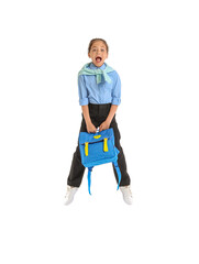 Jumping little schoolgirl on white background
