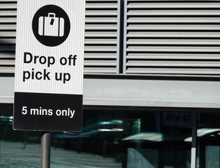 Closeup shot of drop off pick up sign by the road