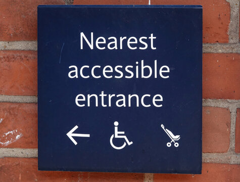 Closeup shot of a Nearest accessible entrance sign on the wall