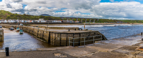 A panorama view across the entrance to the inner harbour at the town of  Cullen, Scotland on a...