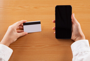 Business woman, holding smartphone with credit card, for pay online shopping e-commerce concept.