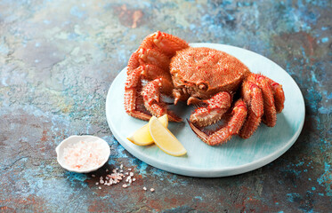 Cooked whole horsehair crab or hairy crab on a wooden plate, selective focus