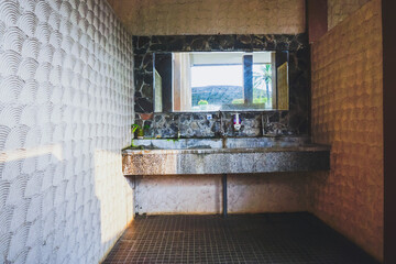 Fototapeta na wymiar Mirror and sink in the toilet. Hotel or apartment interior. 
