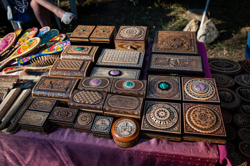 handmade birch bark boxes with images of animals at the fair of masters