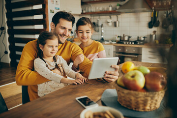 Happy father with daughters take selfie with touchpad at home.