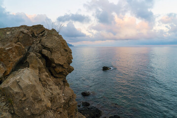 A rock in the shape of a head on the seashore at sunset.Crimea. Choban-kule.