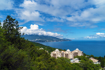 Fototapeta na wymiar View of the sea and Yalta through the foliage of trees. Crimea.