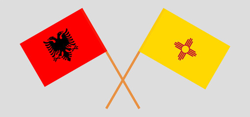 Crossed flags of Albania and the State of New Mexico. Official colors. Correct proportion
